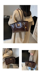 Close-up of brown oil-wax leather tote with metal logo and woven charm detail