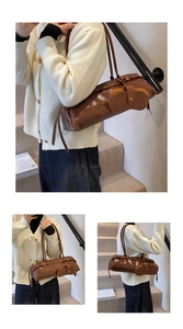Detail view of deep brown vintage oil-wax leather baguette bag with metal rivet accents