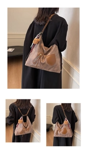 Detail view of vintage stone texture tote bag with teddy charm and striped scarf decoration