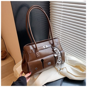 Detail view of a vintage dark brown glossy tote bag with dual front pockets and silver buckles