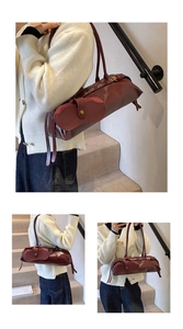 Detail of the vintage dark red baguette bag showing oil-wax leather texture and unique flap
