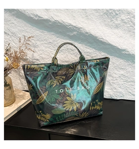 Detailed view of the waterproof PVC tote bag featuring a vintage botanical leaf print design