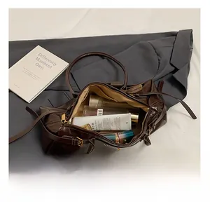 Macro shot showing large interior capacity of dark brown oil wax leather tote bag for storage