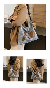 Detailed view of blue denim tote bag with brown leather pockets and teddy bear charm