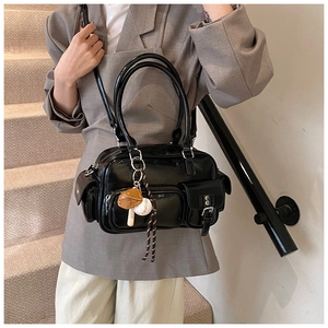 Detail of black glossy PU leather bowling bag with multi-pockets and baseball keychain