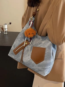 Elegante borsa tote in denim blu con finiture in ecopelle marrone e ciondolo teddy