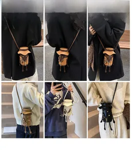 Detailed views of quirky cartoon cylinder crossbody bags in brown, black and cream PU leather