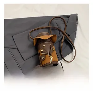 Close-up of creative cartoon crossbody bag with leather legs and gold zipper details