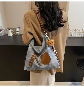 Spacious retro canvas tote bag with silk scarf and teddy charm in a cozy cafe setting