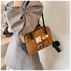Detail of vintage brown suede shoulder bag featuring cute 3D cartoon food plush charms