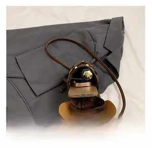 Macro view of brown cowboy hat-shaped crossbody bag showing internal storage capacity