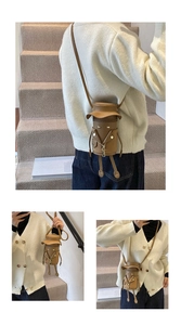Detailed view of brown cartoon doll shoulder bag with star rivets and hat design