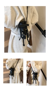 Creative black robot-shaped crossbody bag featuring unique cap and rivet details on leather