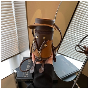 Detail of unique cylinder shoulder bag with creative cartoon figure design and PU leather