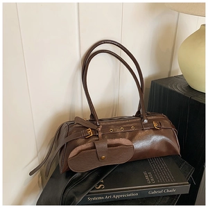 Detailed close-up of retro brown oil wax leather bag texture with vintage metal buckle