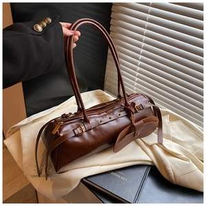 Detailed macro view of vintage oil wax leather texture and gold hardware buckle on bag