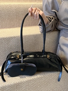 Retro black leather baguette bag with gold metal rings and small accessory pouch