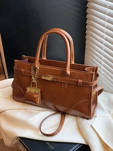 Elegant brown retro leather tote bag with gold buckle and adjustable shoulder strap