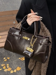 Vintage dark brown leather briefcase handbag for women in a stylish autumn outdoor setting