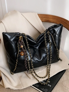 Fashionable black quilted large tote bag with gold chain straps and shiny leather finish