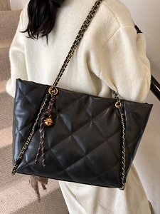 Classic black quilted leather tote bag with gold chain strap and stylish ball charm