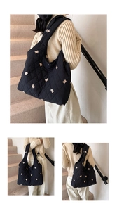 Detail of black quilted tote bag with cute bear embroidery and classic diamond pattern