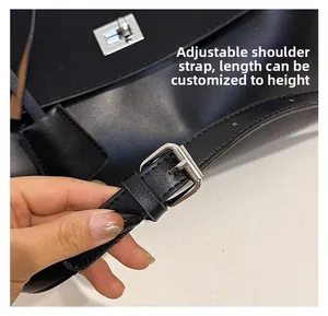 Detail of adjustable black leather strap with silver buckle for crossbody handbags