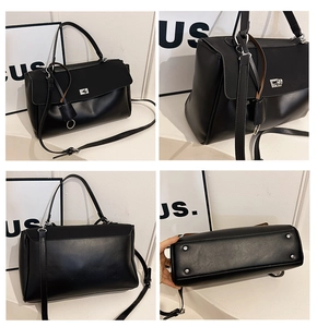 Detail of black handbag with silver twist lock, smooth matte texture and bottom metal studs