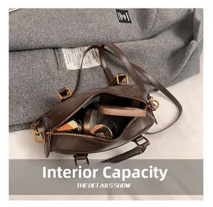 Detail view of the interior capacity of a vintage brown leather Boston bag with zipper