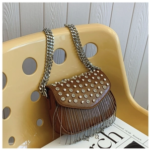 Detailed close-up of brown leather bag with silver rhinestones, fringe and metal chain