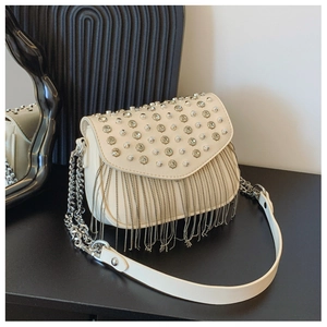 Detailed view of beige crossbody bag featuring shimmering rhinestones and silver chain tassels