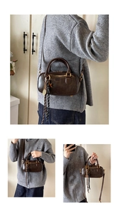 Detailed views of a vintage dark brown Boston bag with smooth leather and tassel charm