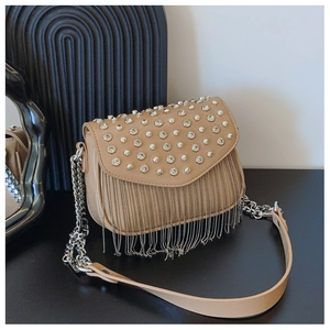 Close-up of beige crossbody bag featuring sparkling rhinestones and silver metal fringe