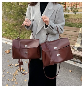 Brown leather handbags in two sizes with silver metal turn-lock and adjustable shoulder strap