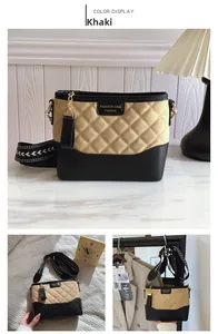 Detail of khaki quilted crossbody bag with black trim and patterned woven strap