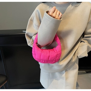 Detail of rose pink quilted cloud bag with puffy texture and silver zipper closure