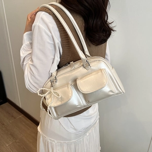 Chic cream white Boston shoulder bag with pearl bow charm and glossy leather finish