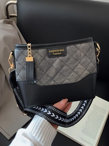Fashionable contrast bucket bag with gray plaid fabric and black leather, stylish crossbody style