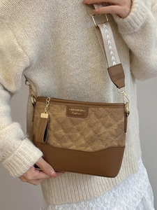 Quilted brown bucket bag with wide woven strap shown on a model for casual look