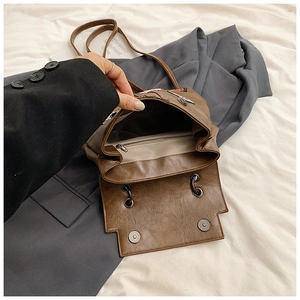 Detail view of brown leather backpack interior with beige lining and zip pocket