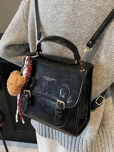 Chic black faux leather mini square backpack with gold lettering and cute bear charm