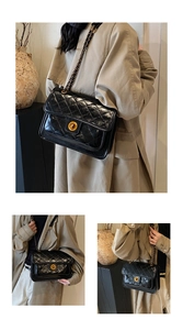 Detail of black quilted leather shoulder bag featuring gold chain strap and metal lock closure