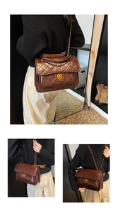Detail shot of the vintage dark brown quilted shoulder bag with golden chain and twist lock