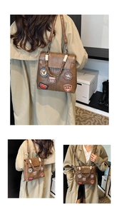 Close-up of vintage brown PU leather backpack with retro patches and rope handle detail
