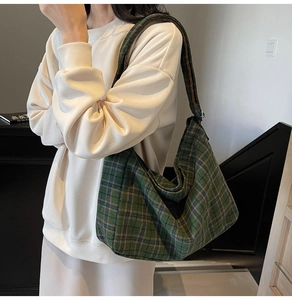 Detail of the green plaid crossbody tote bag showing durable fabric and spacious design