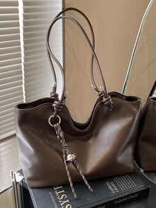 Sophisticated dark brown faux leather tote bag with knot details and creative rope charm