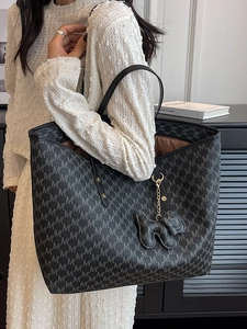 Minimalist black tote bag with MK monogram pattern and cute elephant pendant accessory