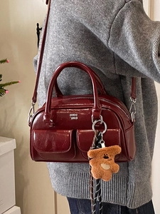 Sac bowling rétro en cuir bordeaux avec deux poignées et charm ours en peluche