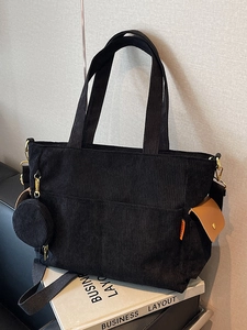 Minimalist black corduroy tote bag with orange flap pocket and detachable round purse