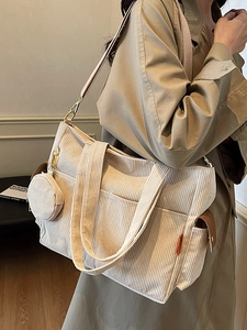 Minimalist beige corduroy tote bag with small coin purse and shoulder strap for daily use